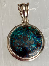 Load image into Gallery viewer, A sterling silver round pendant with chrysocolla stone set in a silver frame with a loop for a chain attachment at the top.