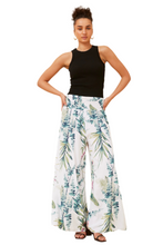 Load image into Gallery viewer, Leaf print flared pants styled with tank top and sandals – casual holiday outfit