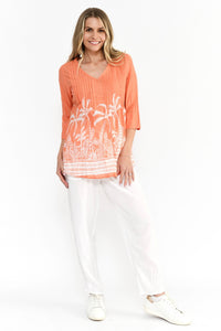 Model wearing Tina V-Neck Pleated Top with white pants