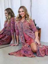 Load image into Gallery viewer, Lady sitting in Bohemian-style Hannah Maxi Dress in luxurious silk blend – Berry Lush Designs.