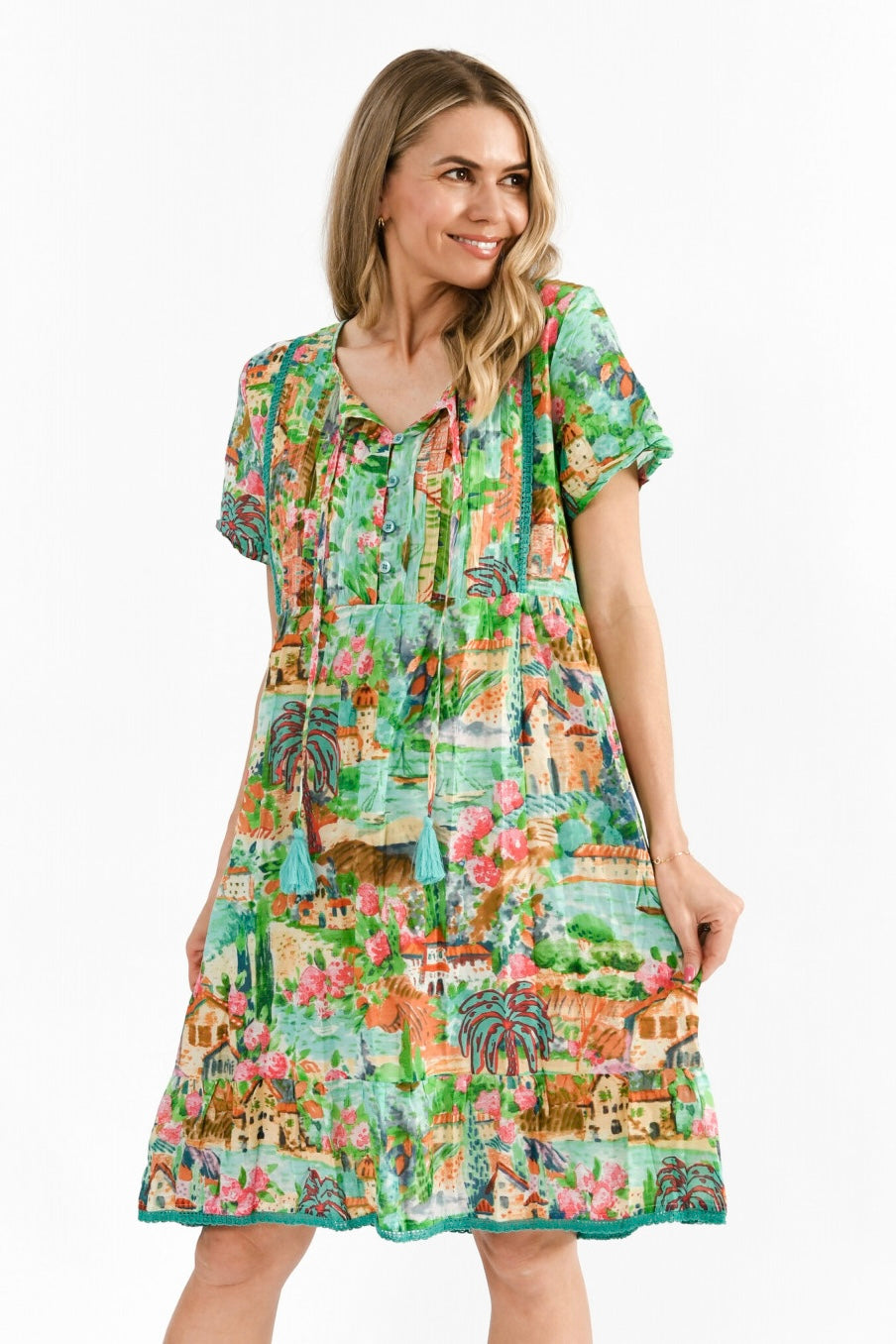 Front view of cotton mint dress with tassel ties and button detail